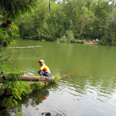 Child on Tree Over Water